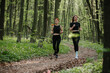 © dsheremeta - Women jogging through a forest trail