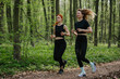 © dsheremeta - Two women jogging in a lush forest