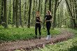 © dsheremeta - Two women jogging on a forest trail