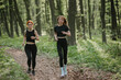 © dsheremeta - Two women jogging on a forest trail