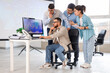 © Pixel-Shot - Team of traders working at table in office