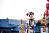 Traditional dressed female performing in a cultural setting Chinese word means traditional.