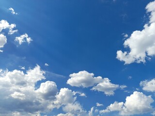 Wall Mural - small white clouds photo of slightly cloudy blue sky