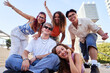 © Gigi Delgado - Happy portrait of a group of multiracial friends enjoying their time together in an urban environment, looking at camera smiling in funny poses.