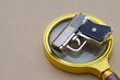 © TeacherPhoto - Crime Scene Evidence: Pistol on Magnifying Glass Depicting Forensic Investigation Process