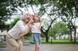 © wattana - Grandmother and little girl spending quality time outdoors, sharing joy and family connection.