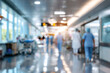 © pilipphoto - Blurred background of a hospital interior with medical equipment and busy hospital staff in motion