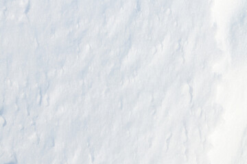 Wall Mural - Beautiful winter background with snowy ground. Natural snow texture. Wind sculpted patterns on snow surface. Wide panoramic texture for background and design.