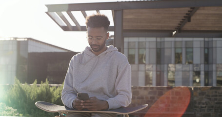 City, skateboarder and man with smartphone, communication or texting with contact, online or website. Outdoor, skater and person with tech for chat, break and networking on social media and mobile