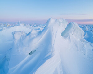 Wall Mural - Winter arctic landscape. Ice hummocks on the frozen sea in the Arctic. View of snow and ice at sunset. Cold frosty winter weather. Harsh polar climate. Amazing nature in the far north in the Arctic.
