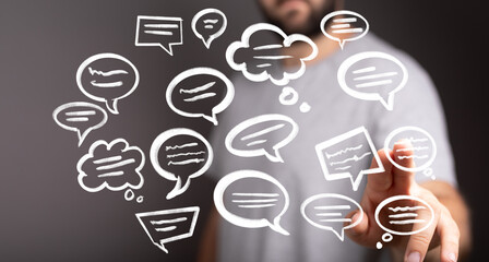 Image of a person interacting with holographic speech bubbles, representing communication, ideas, and feedback.