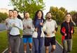 © Studio Romantic - Happy sporty group competition, friends running together along outdoor track exercising for fitness activity showing health and friendship, shared enjoyment, jogging sport team, workung out fun
