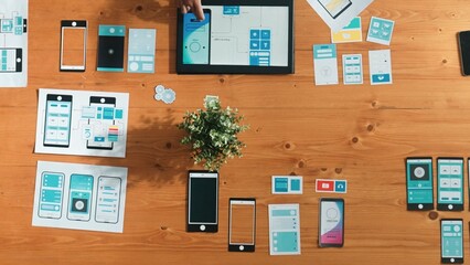 Top view of business man looking and choosing Ux Ui design at meeting room. Skilled developer designing and planning mobile phone interface or software application at creative workplace. Convocation.