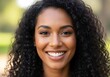 © Jumali - Close-up portrait of a smiling person with curly hair.