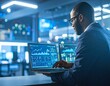 © jadid - Professional financial analyst working on a laptop, examining real-time stock market data charts in a modern office.