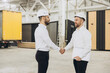 © anatoliycherkas - Engineers shaking hands in modular building factory