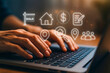 © Aura Stock - Searching for real estate online with icons overlaying a laptop keyboard