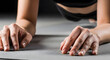 © vickryab - Close-up of sporty woman holding plank on gray mat, dark background. Arms extended, fit, healthy lifestyle