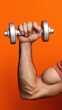 © OleksandrZastrozhnov - Muscular caucasian male arm lifting dumbbell against vibrant orange background