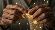 © StockbyJu - Close up of hands creating knitted fabric with warm fairy lights in the background