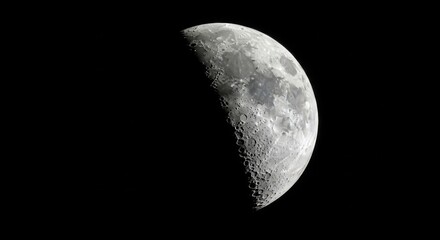 Detailed view of the moon s surface showing craters and texture against black space