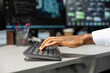 © DC Studio - Close up of engineer typing on keyboard, doing maintenance on server hub to optimize it for artificial intelligence workloads. Technician using PC, inspecting neural network data center