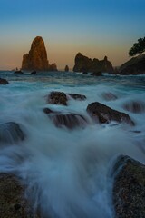 Wall Mural - seascape with waves and sea stacks at sunset