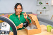 © Guillermo Spelucin - Influencer unboxing new headphones for online product review