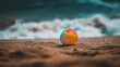 © Ariestia - Colorful beach ball rests on the sand.