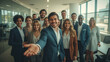 © Janis Smits - The employees of a company are welcoming a new colleague.