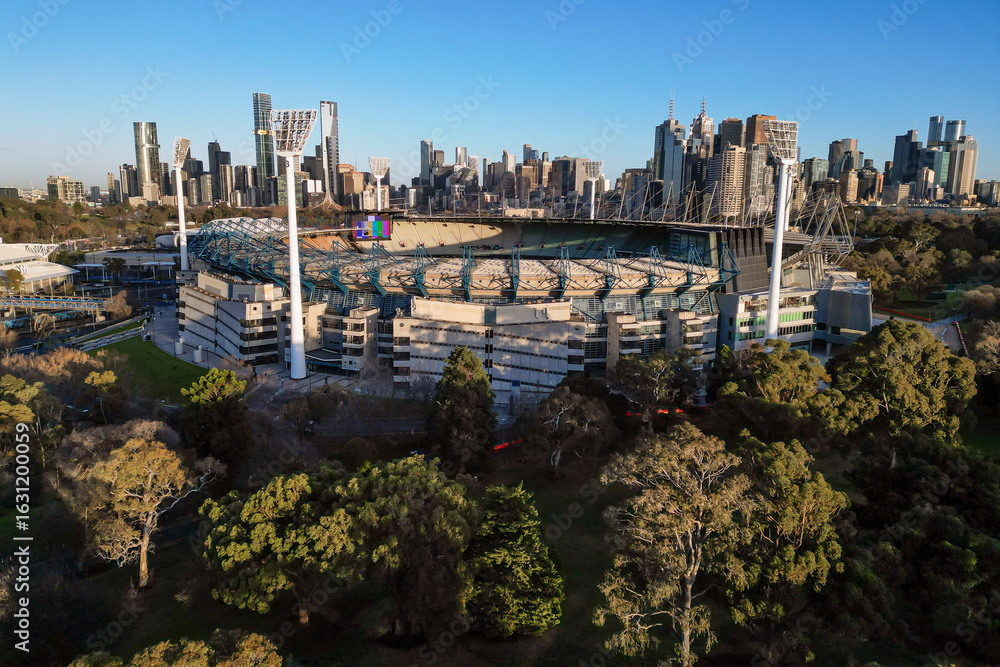The Melbourne Cricket Ground MCG can be seen at sunrise, in front of ...