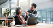© WestLey2000/peopleimages.com - Business celebration, laptop and people with high five for trading success, sales goal or teamwork. Excited man, mature woman and tech with support in office for stock market growth and achievement
