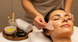 © PNG-RIVER - Woman receiving facial massage with rose quartz gua sha tool at spa