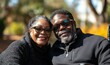 © Shikha Arts - Candid close-up portrait of a disabled middle-aged Black African American couple in a sunny park in wheelchairs, capturing an inclusive and loving moment, Generative AI