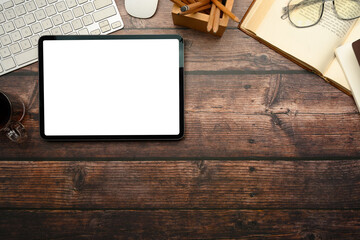 Wall Mural - overhead view of digital tablet, coffee cup, keyboard, and office accessories on wooden table
