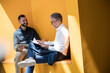 © Westend61 - Manager and colleague discussing work with tablet and notebook in office