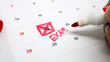 © Reza - A calendar with the number 22 crossed out in red and 'EXAM' written beside it, with a red marker pen nearby, representing the concept of a looming test.