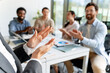 © Maria Vitkovska - Businesswoman receiving applause from colleagues after successful presentation