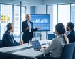 © Yoga - Businesswoman giving presentation to colleagues around a large table in a modern office, displaying financial charts on a screen