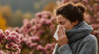 © john - Young caucasian female experiencing seasonal allergies outdoors in park