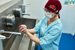 © Georgii - Medical professional washing hands in a sterile hospital environment