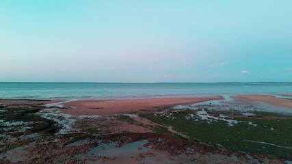 Wall Mural - Tranquil tidal shift: serene seascape with receding waters and exposed sandbars at sunset