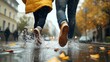© Sirichat. Camphol - laughing couple walking in rain, playful splashes around feet