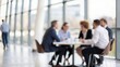 © N7 - Business team gathered around a table — group discussion and collaboration concept