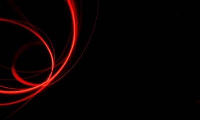 Wall Mural - abstract image featuring bright red glowing light trails and curved lines against a deep black backg