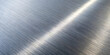 © MUSTAKIM - Abstract closeup of a brushed metal surface, showcasing fine lines, texture, and a bright reflection of light, creating a modern and industrial feel