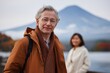 © Andrii Zastrozhnov - Mature caucasian male and asian female enjoy scenic mountain view