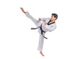 © suphaporn - Martial artist performing high kick in traditional karate uniform isolated on a transparent background, young man in action pose wearing black belt practicing taekwondo or martial arts