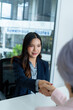 © PIC SNIPE - Job Interview Between Experienced Businesswoman and Young Professional in Bright Modern Office with Positive Energy and Technology