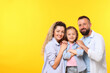© New Africa - Portrait of happy family on yellow background. Space for text